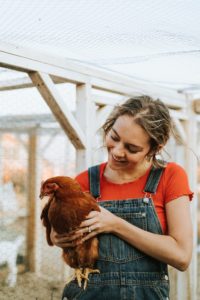 CBD for Pets - woman holding a chicken